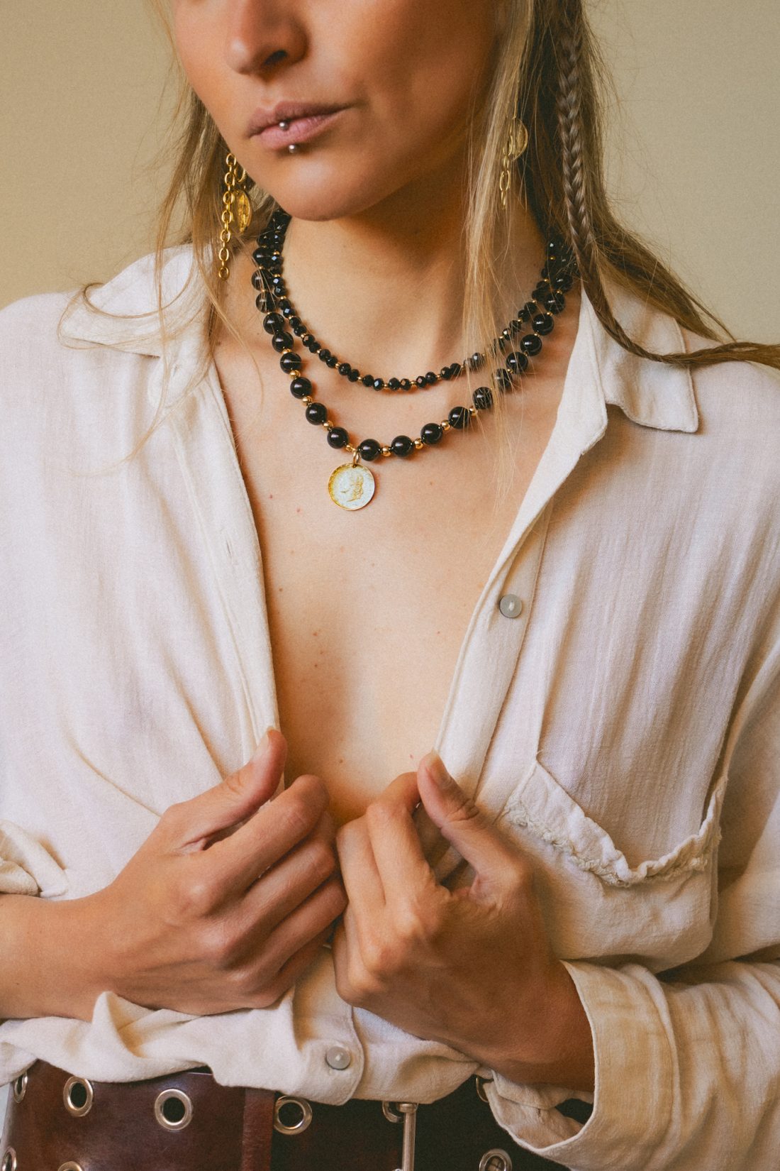 Product photography of a woman wearing Maison Prairie jewelry