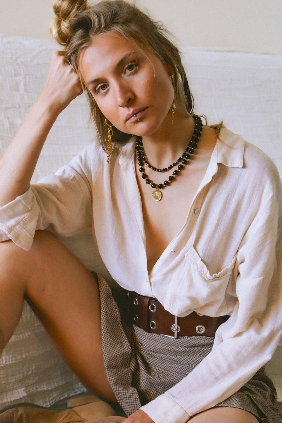 Product photography of a woman wearing Maison Prairie jewelry