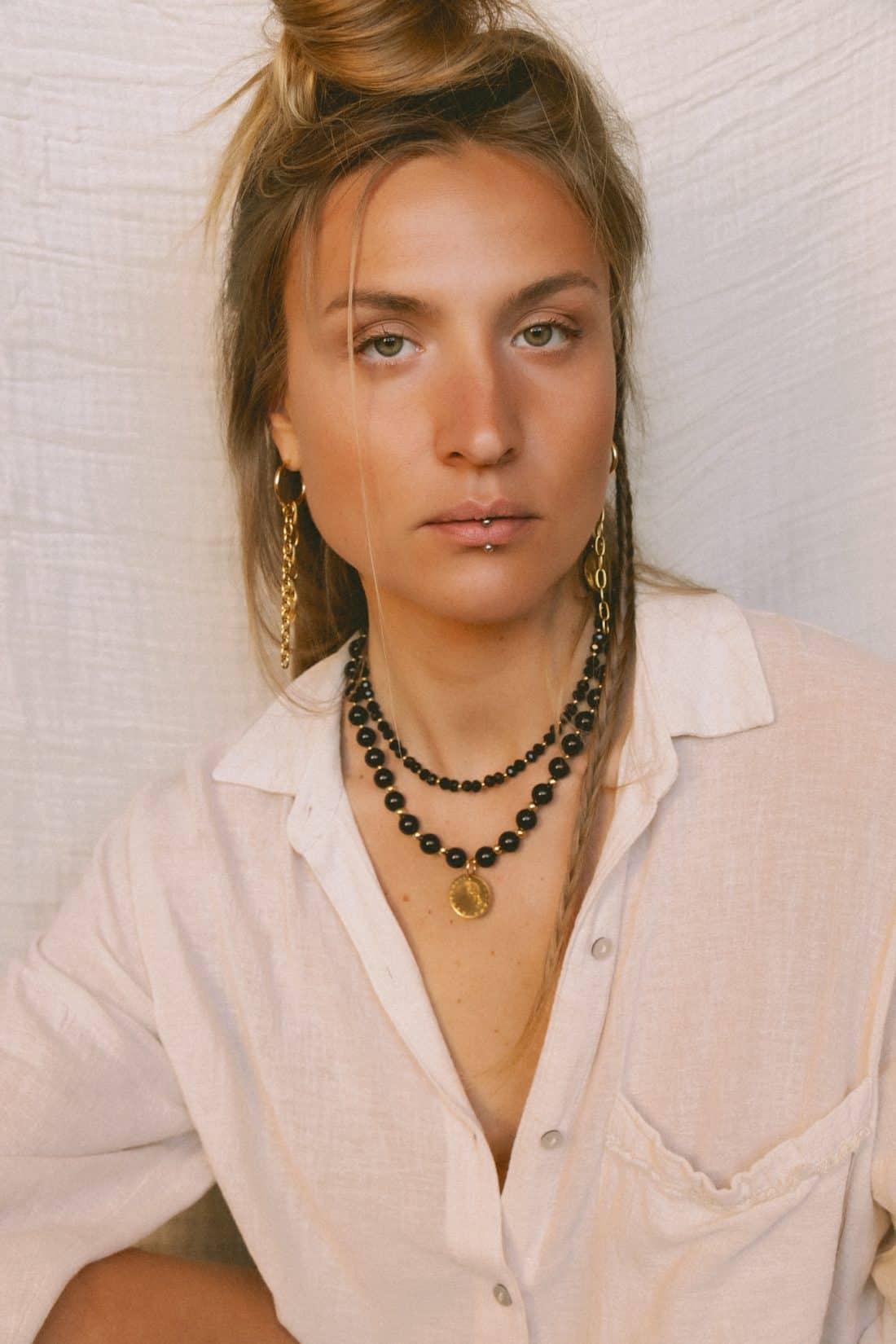 Product photography of a woman wearing Maison Prairie jewelry